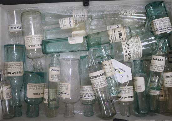 29 vintage labelled glass chemists bottles, a zinc ointment jar and a large collection of chemists labels and packets,